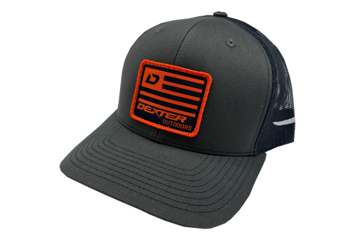 Dexter Outdoors Charcoal and Navy trucker-style hat with front patch that includes the logo and Dexter flag.