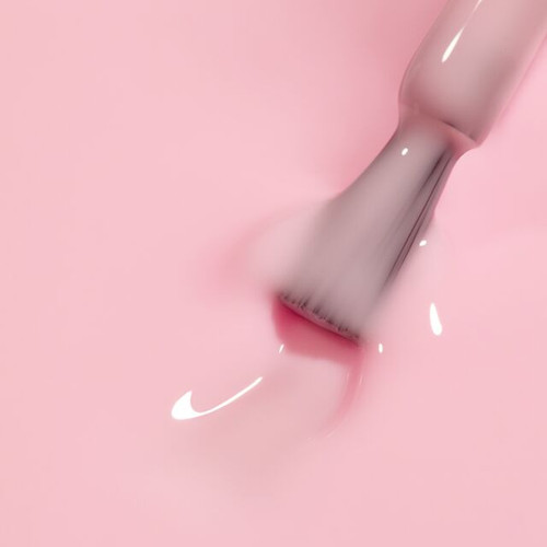 Nail brush gliding through The GelBottle Inc’s Fancy BIAB pastel pink builder gel infused with warm tones and a jelly-cream finish