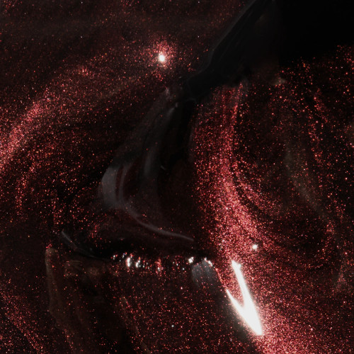 Nail brush swirling through Getaway Mini classic shimmering dark red gel polish from The GelBottle Inc's Heist Collection