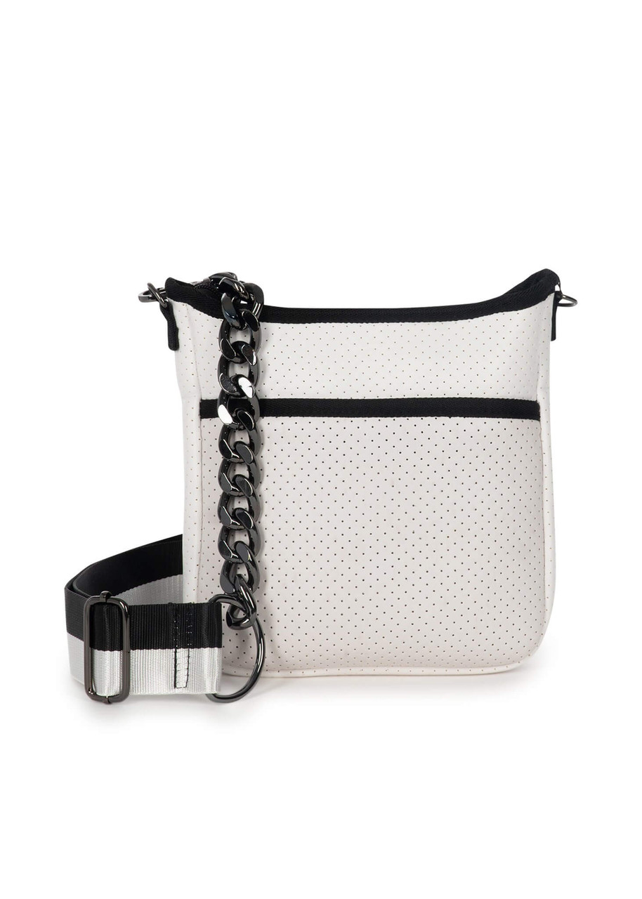 White coated perforated neoprene crossbody.

2 straps included: black / white stripe with gunmetal chain, and black with metallic star design

Small crossbody with top zipper closure and hidden front zipper pocket. 

8.5" W x 2" D x 9.5" H