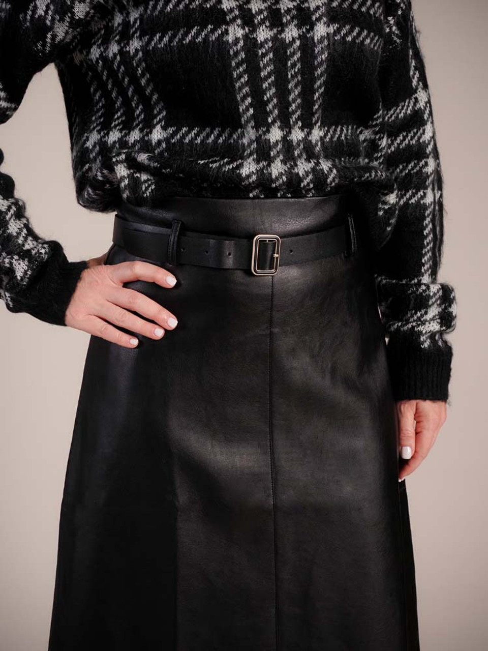 Buttery black faux leather high-waisted pencil skirt. Matching belt at waist with black and soft gold buckle, center seam at front with 9" split, 2 pleats and a center seam at back, 28" long, lined half way down from waist