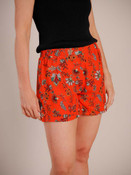 Redish orange floral shorts with metalic thread detail. Elastic waist