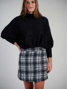 Soft white/black plaid skirt. Zipper and hook/eye close at left side, darted in back for shape, fully lined, 16" long