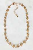 Gold-tone necklace with alternating knot and oval links. Adjustable from 16" - 19"; lobsterclaw clasp; nickel and lead free.