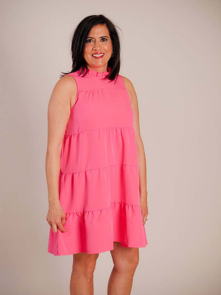 Ruffle collar; sleeveless; wide ribbon tie at back of neck; pleated horizontal seams across body of dress Ruffle collar; sleeveless; wide ribbon tie at back of neck; pleated horizontal seams across body of dress