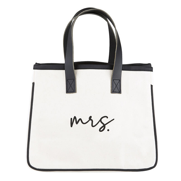Small and easy to tote around your wedding day and then everyday essentials! Canvas and genuine leather; 10" L x 12" W x 6.5" D, 5.25" handle drop. Small and easy to tote around your wedding day and then everyday essentials! Canvas and genuine leather; 10" L x 12" W x 6.5" D, 5.25" handle drop.