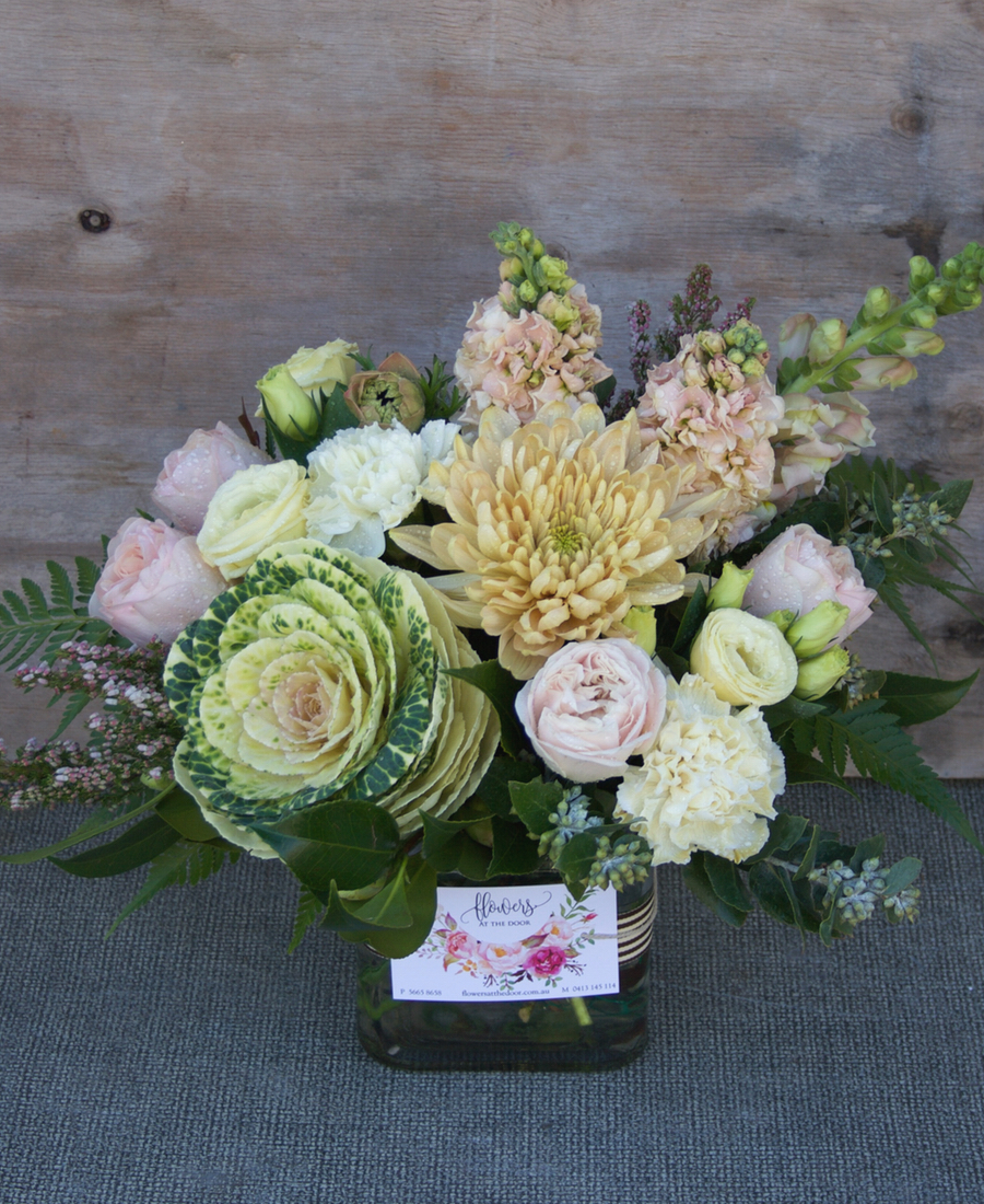Small Vase Of Flowers And Candle Flowers At The Door