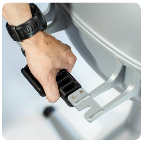 The PK360 Grill & Smoker, close-up of hand adjusting the sturdy metal leg support with a black grip handle for stable grilling and smoking, AmazingRibs.com Special Offer.