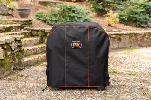 PK Grills The NEW PK300 Slim Cover, outdoor grill cover protecting a portable grill on a garden pathway.