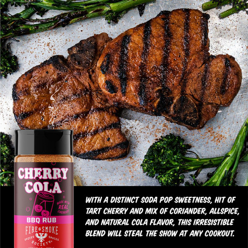 Fire & Smoke Society F&S Cherry Cola 6.7OZ bottle with BBQ rub on grilled meat and fresh greens, highlighting the product's soda pop flavor with cherry and cola notes.