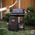 PK Grills PK300AF Start Cookin' Bundle - Coal, outdoor charcoal grill with accessories in a backyard setting.