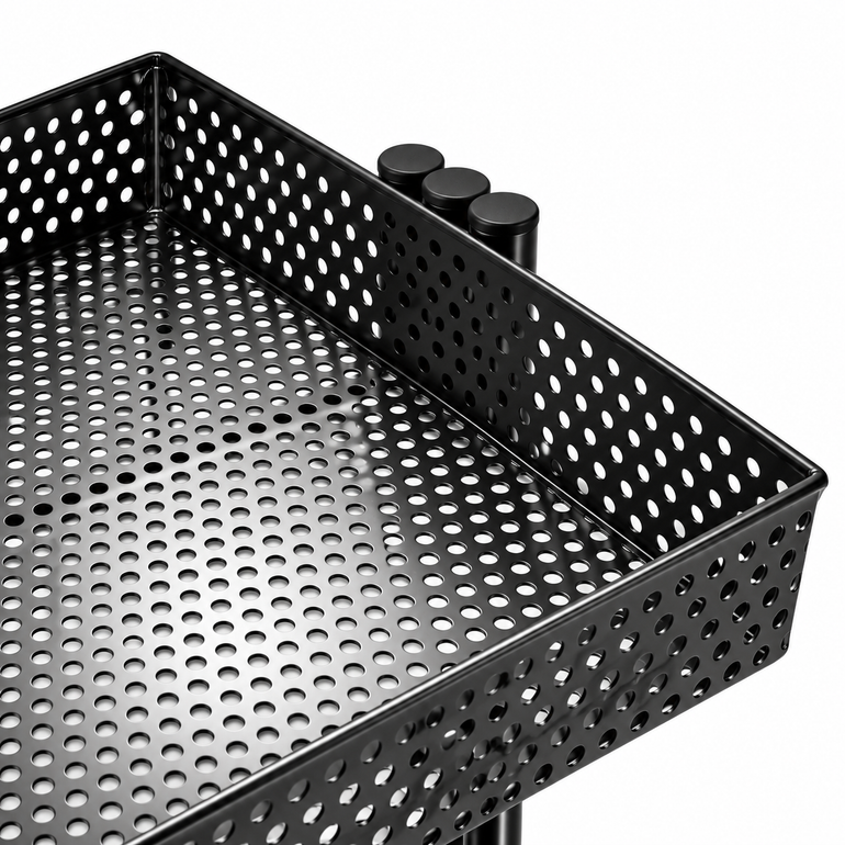 Close-up of black perforated salon trolley tray showing the durable hole-patterned storage surface and raised edges.
