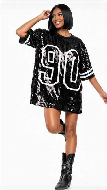 Black sequin oversized 90 jersey dress with white striped sleeves styled with black cowboy boots for women’s game day fashion.