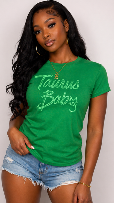 Black woman wearing green Taurus Baby t-shirt with denim shorts
Taurus zodiac graphic tee for women green shirt front view
Stylish Taurus Baby outfit casual summer look
Astrology shirt women Taurus green tee outfit