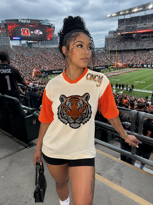 Turn heads on game day with our CINCY Rhinestone Mesh Jersey featuring a sparkling tiger design, breathable mesh fabric, and an oversized fit. The perfect Cincinnati-inspired football jersey for tailgates, stadium outfits, and everyday fan fashion