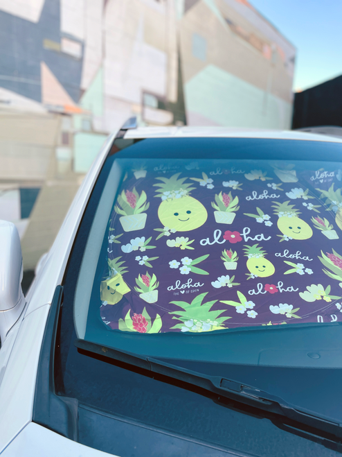 sun shade in car with pineapples and flowers on it