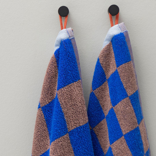 Mette Ditmer Retro Bath Towels in Cobalt Hanging On Hook