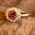 PINK TOURMALINE AND DIAMOND RING features 0.04 carats round brilliant diamonds in a decorative halo around the center stone