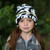 Super soft luxury cotton baseball hat  with soft peak. The sunhat features ears and roll up neck protector. The neck protector is lightweight with a contrast green camo print on the reverse. Available in sizes from 0 - 5 years