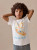 Bonpoint Thibald T-Shirt Ecru 26SS - This Thibald T-shirt for boys is an essential piece to pack for a sunny vacation. Made in organic cotton, it features a Bonpoint planet tag on the sleeve. Bonpoint Thibald T-Shirt Ecru 26SS - This Thibald T-shirt for boys is an essential piece to pack for a sunny vacation. Made in organic cotton, it features a Bonpoint planet tag on the sleeve.