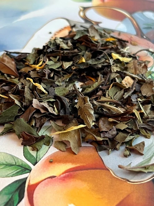 Just Peachy is a delightfully smooth white tea that captures the sweet, sun-ripened flavor of fresh peaches in every sip. Delicate white tea leaves provide a light, refreshing base, while cheerful calendula petals add a touch of natural beauty. Low in caffeine and wonderfully mellow, this fruity blend is perfect for slow mornings, peaceful afternoons, or whenever life calls for a little peachy pick-me-up.

Why loose leaf tea?
Loose leaf tea holds more of what nature intended: fuller flavor, richer aroma, and the space to unfurl and release its true character in every cup. We honor that process and bring you tea that’s always extraordinary.

Our Commitment
At White Cloud Tea Company, we are devoted to offering only the freshest, most flavorful loose leaf teas. We believe that tea should be a sensory experience—vibrant, aromatic, and full of life. That’s why we source with care and blend with intention, using whole leaves, real botanicals, and no shortcuts.

Steeping Instructions:
1 tsp per 8 oz | 155-170° F | Steep 3-5 min

Ingredients: white tea, natural flavor, peach, calendula
Caffeine level- low




