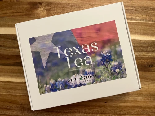 Texas Teas Gift Box
Bring a little taste of Texas to your teacup! Our Texas Teas Gift Box features four flavorful blends inspired by the comforting, fruity, and sweet flavors tea lovers enjoy. From a classic breakfast black tea to peachy herbal tea, rich caramel pecan rooibos, and fruity Spanish Sangria, this collection offers something special for every mood.
Whether you’re celebrating a birthday, sending a thoughtful thank you, or treating yourself to a little Texas-inspired tea time, this gift box is a wonderful way to sip, savor, and share.

Your Texas Teas Gift Box Includes:

Lone Star Breakfast Black Tea
A classic black tea with a bold, satisfying flavor, perfect for starting your morning or enjoying a comforting cup any time of day.

Hill Country Peach Herbal Tea
A sweet, peach-inspired herbal infusion that brings a little taste of the Texas Hill Country to your teacup.

Caramel Pecan Rooibos
A smooth, naturally caffeine-free rooibos blend featuring comforting caramel sweetness and nutty pecan flavor.

Spanish Sangria Herbal Tea
A vibrant, fruit-filled herbal infusion inspired by the fruity flavors of Spanish sangria, offering a colorful and refreshing tea experience.

This collection brings together classic tea comfort and fun, flavorful blends, making it a thoughtful gift for tea lovers and anyone who enjoys discovering something new.

Share a little Texas charm, one delicious cup at a time!
