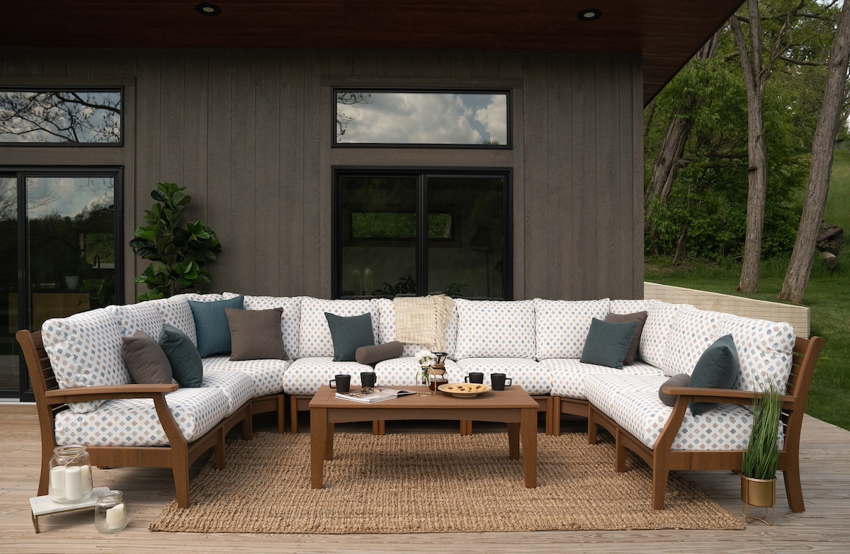 Weather-resistant poly deep seating sectional with Sunbrella cushions in a backyard setting