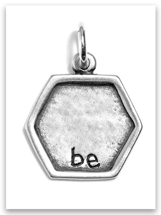 Hexagon-shaped silver charm engraved with the word 'be' in lowercase letters, inspired by Proverbs 16:24. Minimalist and meaningful faith-based jewelry piece. Hexagon-shaped silver charm engraved with the word 'be' in lowercase letters, inspired by Proverbs 16:24. Minimalist and meaningful faith-based jewelry piece.