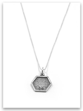 Hexagon-shaped silver charm engraved with the word 'be' in lowercase letters, inspired by Proverbs 16:24. Minimalist and meaningful faith-based jewelry piece. Hexagon-shaped silver charm engraved with the word 'be' in lowercase letters, inspired by Proverbs 16:24. Minimalist and meaningful faith-based jewelry piece.