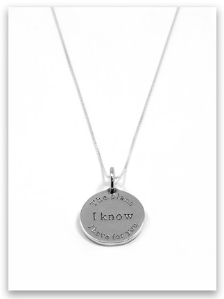 Round silver charm engraved with the words 'the plans I have for you' surrounding 'I Know' in bold, inspired by Jeremiah 29:11. Simple, faith-based jewelry piece. Round silver charm engraved with the words 'the plans I have for you' surrounding 'I Know' in bold, inspired by Jeremiah 29:11. Simple, faith-based jewelry piece.