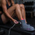Person wearing Novaa Lab Light Boots red light therapy boots while seated for targeted foot, ankle, calf, and lower-leg recovery support