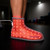 Person reclining while using Novaa Lab Light Boots red light therapy boots for targeted foot, ankle, calf, and lower-leg recovery support