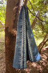 Blue and white indigo-dyed cotton scarf hanging in tree