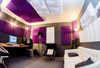 Installation of Auralex Studiofoam® Wedges™ - 2" x 24" x 24" - on walls and ceiling with Auralex LENRD® Bass Traps in corners - shown in Purple and Auralex T’Fusor™ 3D Sound Diffusors on walls and ceiling - shown in White.