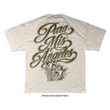Natural bone premium heavyweight tee, back. Large airbrushed sepia script reading "Para Mis Ángeles" above two cherub angels, flanked by dates "2011" and "2016," with "Born For This" in script beneath.