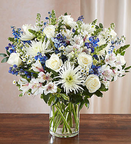 Sincerest Sorrow Blue & White
A sincerity of sentiment means so much to those grieving. Our bountiful, heavenly blue and white bouquet features a soothing mix of blue delphinium, alstroemeria, and white roses, hand-designed inside a classic clear glass vase. When sent to a service or to the home of family or friends, it makes a genuinely heartwarming gesture.
