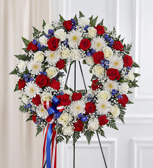 They served their country with honor and pride, so it's only fitting to honor them with a beautiful symbol of eternal life. Our patriotic standing wreath arrangement is meticulously crafted by our expert florists to honor a brave veteran who has passed away. Filled with lush blooms in red, white and blue, it's a fitting final tribute for the funeral services.