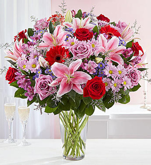 For the one you adore above all else, here's a surprise designed to wow! Our spectacular arrangement is filled with an abundance of lush blooms in soft & bold shades for an exciting contrast of color. Artistically hand-designed by our expert florists, it's a beautiful gift that expresses the depths of your love.