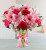 This artfully designed vase includes pink gerbera daisies, pink lilies, red and pink roses, and alstromeria, finished off with a pink bow around the vase.