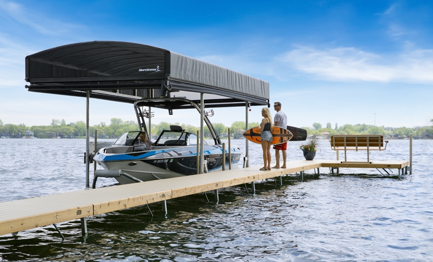 a man and woman standing on a dock next to a boat