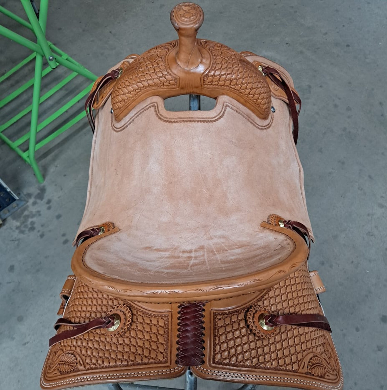 New All Around Saddle by Fort Worth Saddle Co with 15 inch seat. Built on our new proprietary Jplus "hog-bars" roping tree, our new all-around saddle is lightweight, but can be roped from. Limited lifetime warranty on tree. Constructed of Hermann Oak leather. Hand tooled. Secure pencil roll seat. Drop-rigged for added stability. Gullet size is 7.25 inch, weight is 32lbs, and skirt is 26.5 inch. Made in USA. Limited lifetime warranty.

S1397