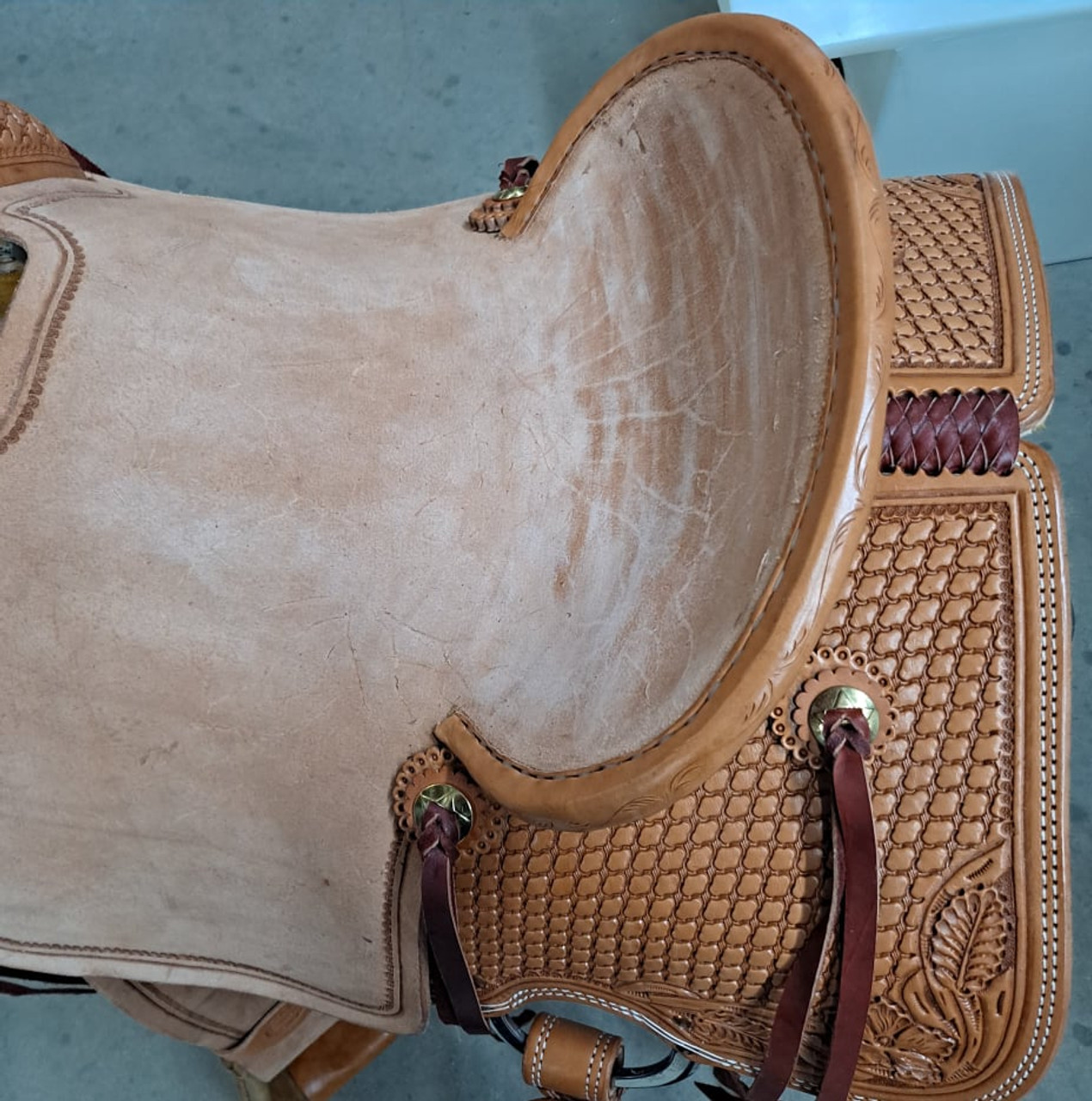 New All Around Saddle by Fort Worth Saddle Co with 15 inch seat. Built on our new proprietary Jplus "hog-bars" roping tree, our new all-around saddle is lightweight, but can be roped from. Limited lifetime warranty on tree. Constructed of Hermann Oak leather. Hand tooled. Secure pencil roll seat. Drop-rigged for added stability. Gullet size is 7.25 inch, weight is 32lbs, and skirt is 26.5 inch. Made in USA. Limited lifetime warranty.

S1397