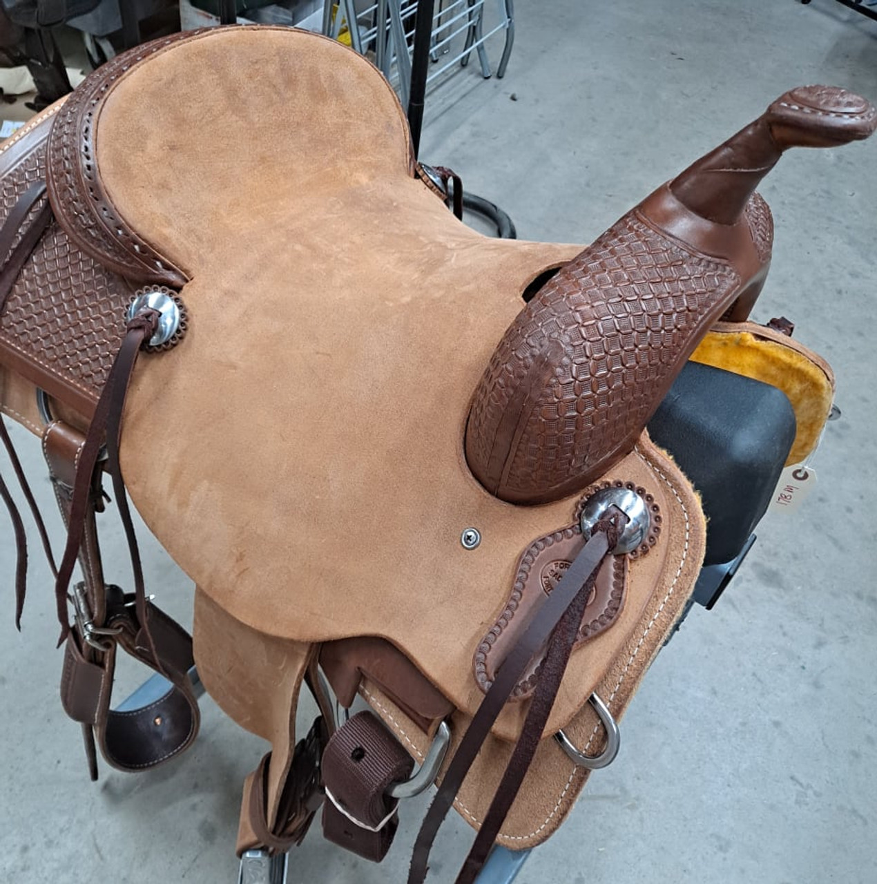 New Cutting Saddle by Fort Worth Saddle Co with 15 inch seat. Hermann Oak leather. Roughout contact points and skirt. Hand tooled rear chassis, cantle, and pommel. Gullet size is 7.25 inch, weight is 36lbs, and skirt is 27.25 inch. Made in USA. Limited lifetime warranty.

S1491