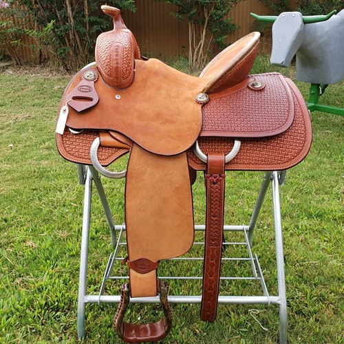 NEW 13.5" PLAYDAY SADDLE
Got a young rider who likes play-days and trails, but doesn't want a barrel saddle? This one offers the best of both worlds... the secure deep roughout pencil roll seat and barrel stirrup performance combined with the general appearance of a buckaroo saddle. It can be as serious a saddle as they want, as it's built on a youth sized version of our Mounted Shooter tree.

Pick your own stirrups and conchos. We CAN shorten fenders if needed. Includes latigo, offside, matching leather flank billets and flank cinch, and cinch hobble.

NOT some cheap toy saddle... This is a serial numbered real leather Texas built hand tooled Fort Worth Saddle Co saddle with a US made rawhide over hardwood tree. Your young rider may someday pass it down to their own buckaroo.

 Gullet size is 7 inch. Made in USA. Limited lifetime warranty.

S694