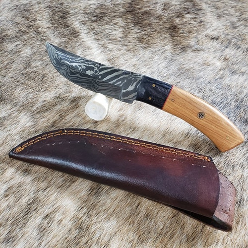 Skinner.Damascus Steel. Total length is 8 inches with 4 inch blade. Handle is Wood. Vertical  sheath included.