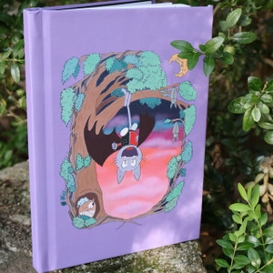 purple hardcover journal featuring anime inspired woodland sunset scene with cute cat disguised as a bat