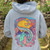 Unisex hoodie featuring colorful vaporwave art kawaii dragon, anime inspired design