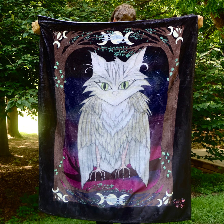 plush blanket featuring mystical creature design with a cat combined with an owl "meowl"