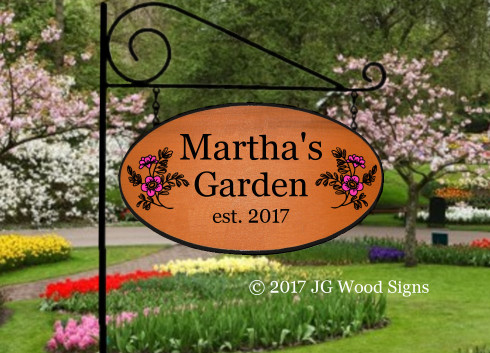 Carved garden signs highlight a flower garden passion