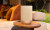 Denon Home 200 – Wireless Smart Speaker with HEOS® stone outside on a table